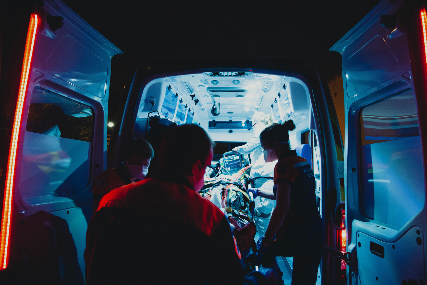 EMS personnel providing patient care inside an ambulance
